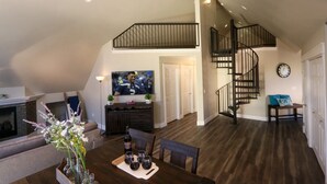 A spacious loft with a dining area, a living room, and a staircase. - Bright Loft Near Wineries & Park | Sleeps 6 (College Place)