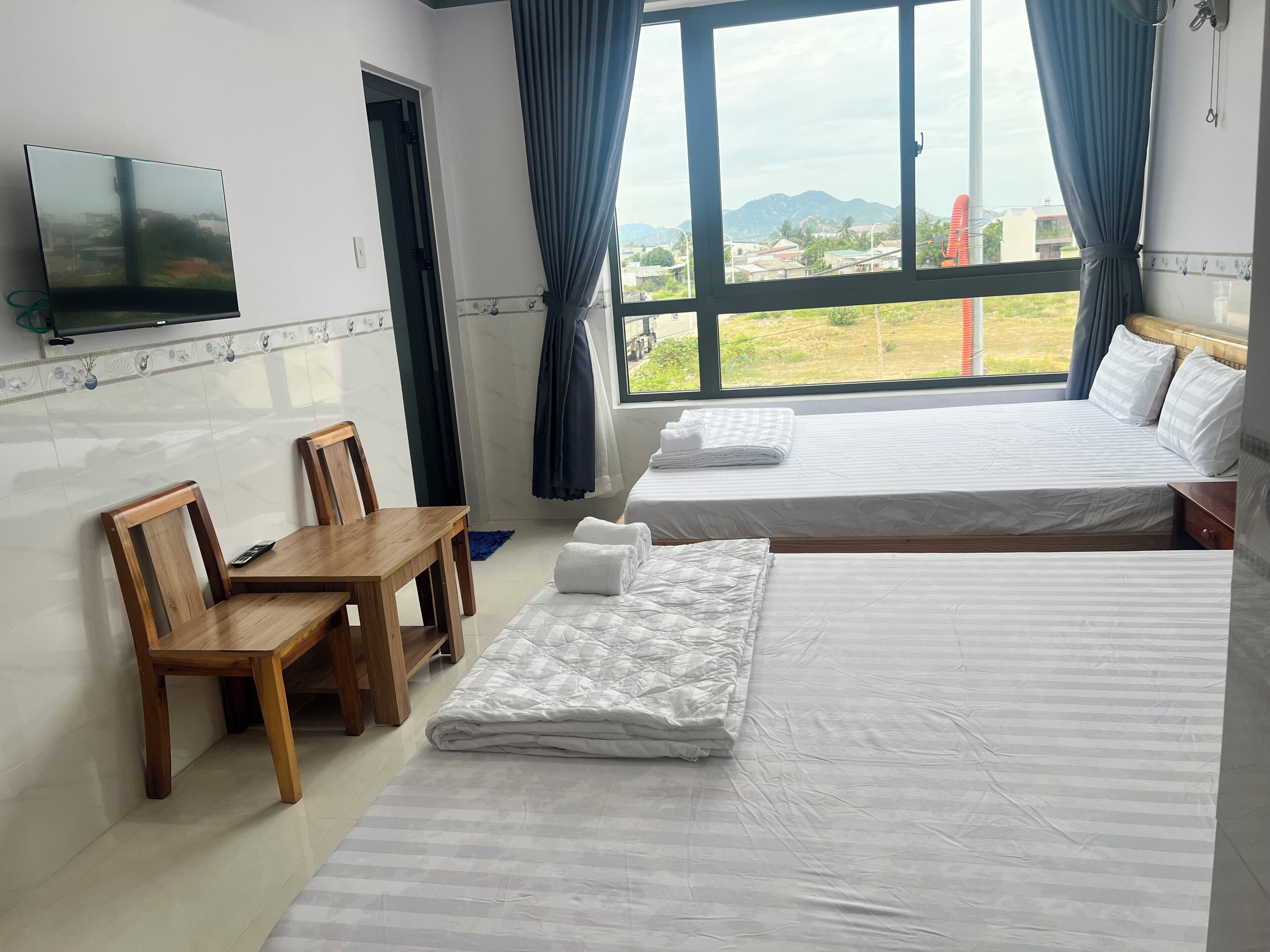 Basic Quadruple Room, City View | Desk, laptop workspace, free WiFi
