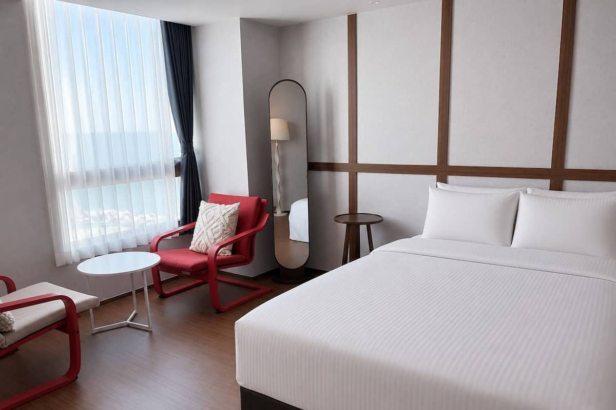 Habitación doble Deluxe, para no fumadores, vista parcial al océano | Ropa de cama de alta calidad, cortinas blackout y insonorización