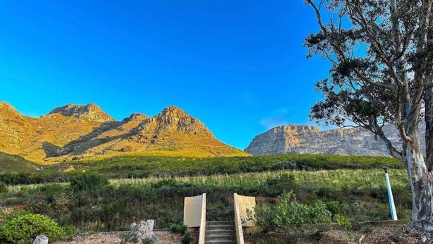 A staircase leading to a mountain view with a clear sky. - Table Mountain Escape, Mountain and sea Views (Cape Town)