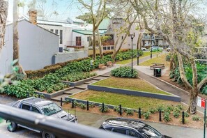 A residential area with houses, a pathway, and a car parked on the street. - Spacious 2 bedroom apt with parking (Surry Hills)