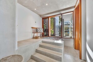 A staircase leading to a balcony with a view of a building and greenery. - Stunning 3-BR Architectural Gem Villa (Watsons Bay)