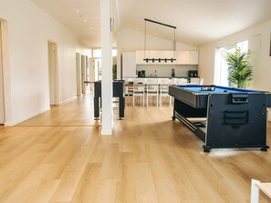 A modern interior with a pool table, a dining area, and a kitchen. - 5 Star Holiday Home in Saltum (Saltum)