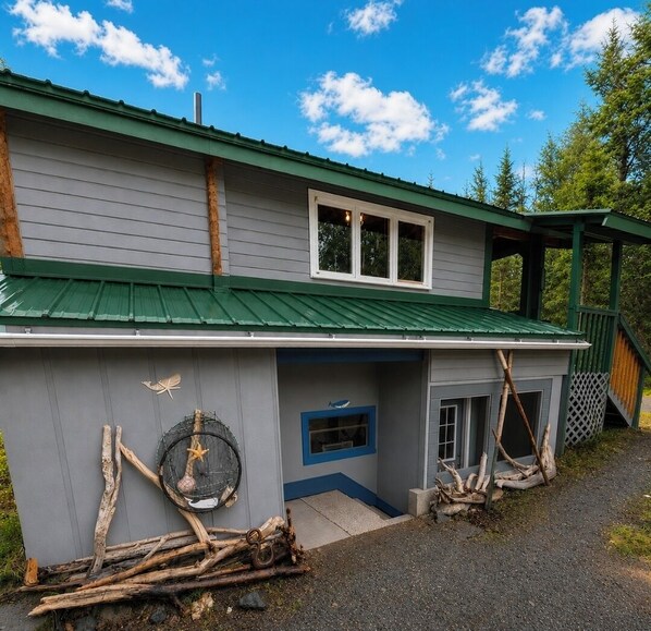 A two-story building with a green roof, a covered porch, and a small front entrance. - Whaler's Cove, pleasant 1-bedroom/1 bath apt. in Kenai perfect for your getaway. (Kenai)