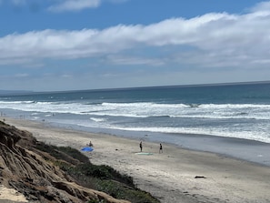 A beach with waves, people, and a clear sky. - Walk to the Beach... (Carlsbad)