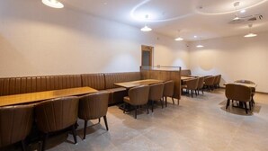 A restaurant with booth seating, high tables, and chairs.
