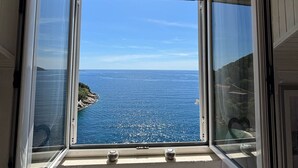A view through a window with a clear sky and a coastline. - Sweet Place by Jasminka (Tisno)