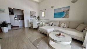 A spacious living area with a sofa, coffee table, and dining table. - Sweet Place by Jasminka (Tisno)