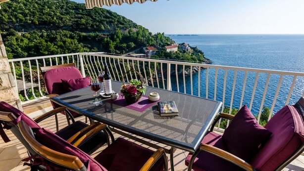 A terrace with a table set for two, overlooking a coastal landscape. - Sweet Place by Jasminka (Tisno)