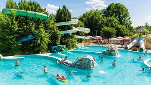 Een waterpark met verschillende glijbanen en een zwembad.