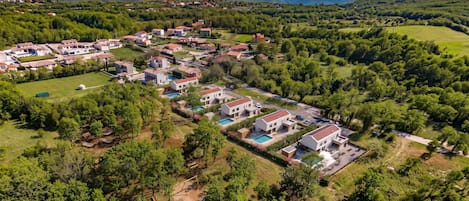 A residential area with houses, a swimming pool, and a park.