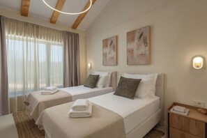 A hotel room with two beds, a bedside table, a lamp, and artwork on the wall. - Nareo Villa Collection With Private Pool (Sveta Nedelja)