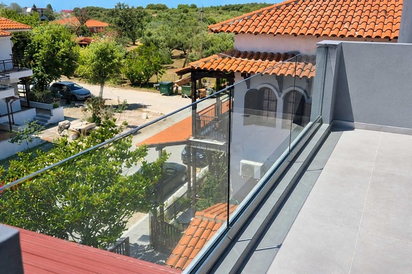 Spacious Balcony Terrace with Glass Railings and Village Views