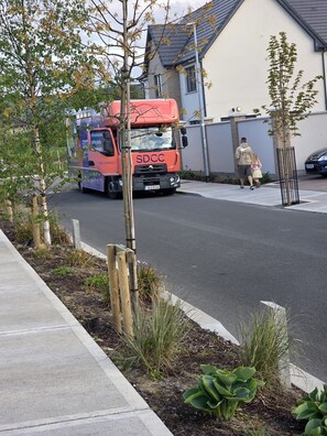 A red SDCC truck parked on a residential street. - Ensuite room to lett (Dublin)