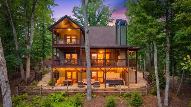 A two-story log cabin with a balcony, a fireplace, and a stone pathway leading to the entrance. - Mt View, Spa, Firepit, EV Chrgr & Pvt Riverside Pk (Blue Ridge)