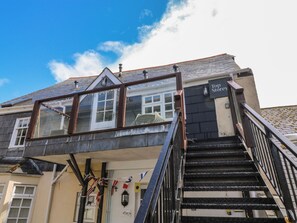 A building with a staircase leading to a top storey, a balcony with a view, and a sign indicating the name 'Flati 1'. - Top Storey (Dartmouth)