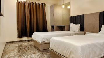 Deluxe Triple Room, Garden View | Desk, laptop workspace, soundproofing, iron/ironing board
