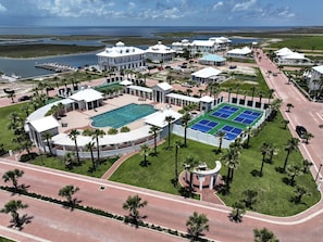 A resort with a swimming pool, tennis courts, and a marina.