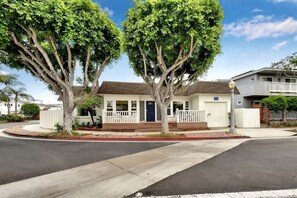 A two-story house with a front porch, a garage, and a driveway.
