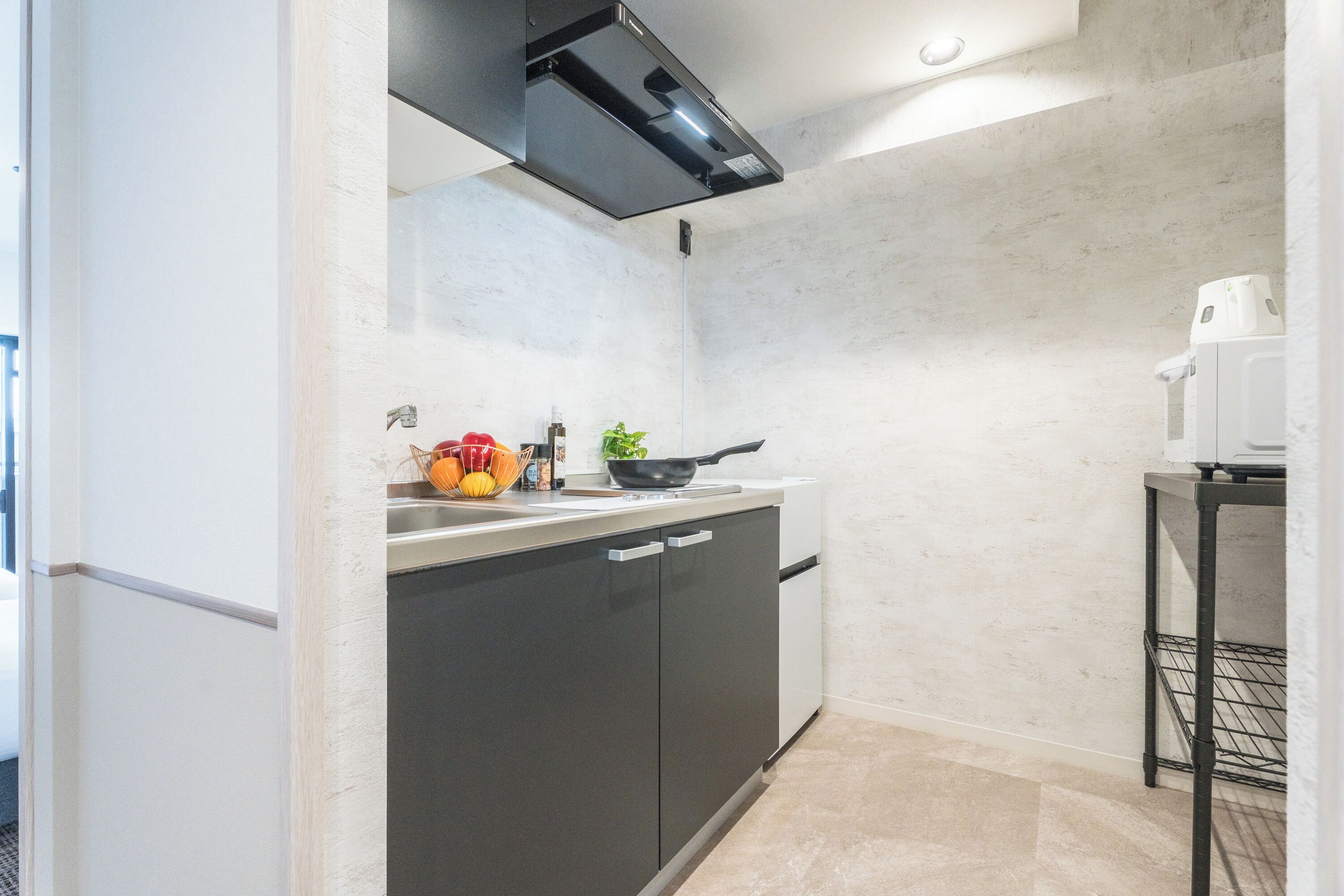 A compact kitchen with a dishwasher, a stove, and a small countertop.