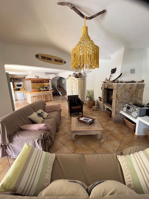 A living room with a sofa, coffee table, and a fireplace. - Family home located 2 minutes from downtown and the port of Porto Vecchio (Porto-Vecchio)