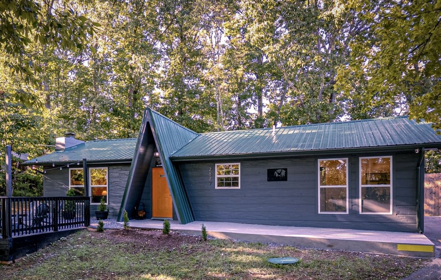 A house with a sloped roof, a front porch, and a mailbox.