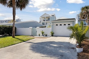 A residential house with a front yard, a driveway, and a garage.