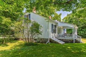 A single-story house with a porch, surrounded by trees. - Cute Rustic Farmhouse Cottage Near the Coast in Southwest Harbor, Maine (Southwest Harbor)