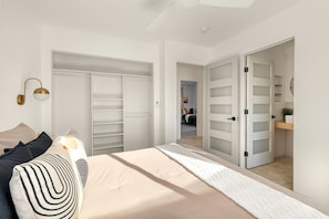 A bedroom with a bed, bedside tables, a wardrobe, and a closet. - Dreamy Vacation Rental with Fire Pit and Fantastic Desert Views in Yucca Valley, California (Yucca Valley)