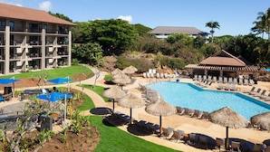 A resort with a swimming pool, lounge chairs, and thatched umbrellas. - Family Retreat: 2BR Villa at Sheraton Kaua‘i Resort (Koloa)