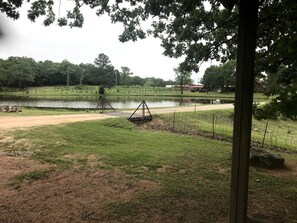 A park with a swing set, a pond, and a path.