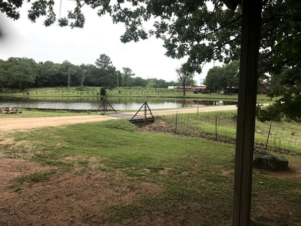 A park with a swing set, a pond, and a path.
