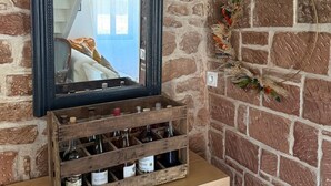 A mirror with a wooden crate below it containing bottles.