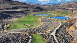 A golf course with multiple ponds, surrounded by rocky terrain and distant mountains. - NEW Beautiful 2-bedroom condo in Granby perfect for your getaway (Granby)