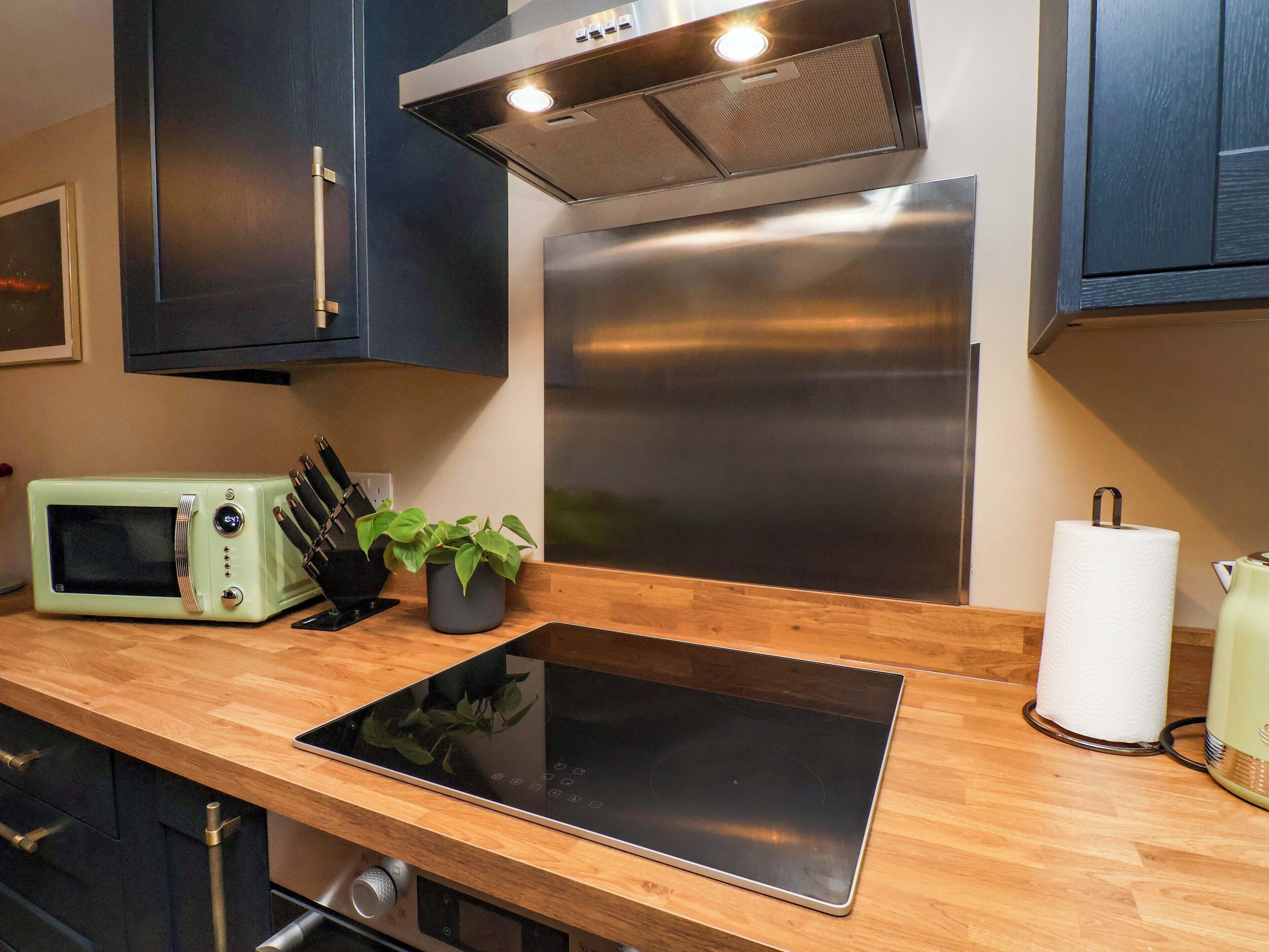 A modern kitchen with a built-in microwave, a stove, and a sink.