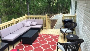 A deck with a sofa, a coffee table, and chairs. - Spacious Modular Rental on Huge Horse and Cattle Farm near Charlottesville, Virginia (Gordonsville)