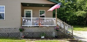 A house with a porch, a flag, and a number '7' on the door.