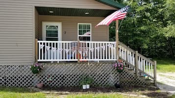 A house with a porch, a flag, and a number '7' on the door.