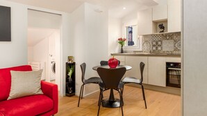 A compact living space with a dining area, kitchenette, and a red sofa. - A comfortable and welcoming 30 square meters studio apartment, perfect for three people, located on the fourth floor of a renovated building (no elevator).The property is situated in the heart of Modena (within the ZTL restricted traffic zone); it is an  (Modena)