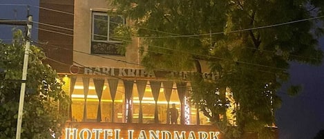 A multi-story hotel with a prominent sign reading 'HOTEL LANDMARK.'