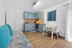 A compact living space with a kitchenette, a dining table, and a sofa. - Vista Marina Seaside Comfort (Santa Cruz de Tenerife)