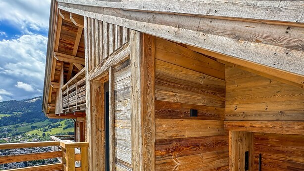 A wooden cabin with a balcony overlooking a valley. - Coeur de Mage: Stunning View of Megève (Megève)
