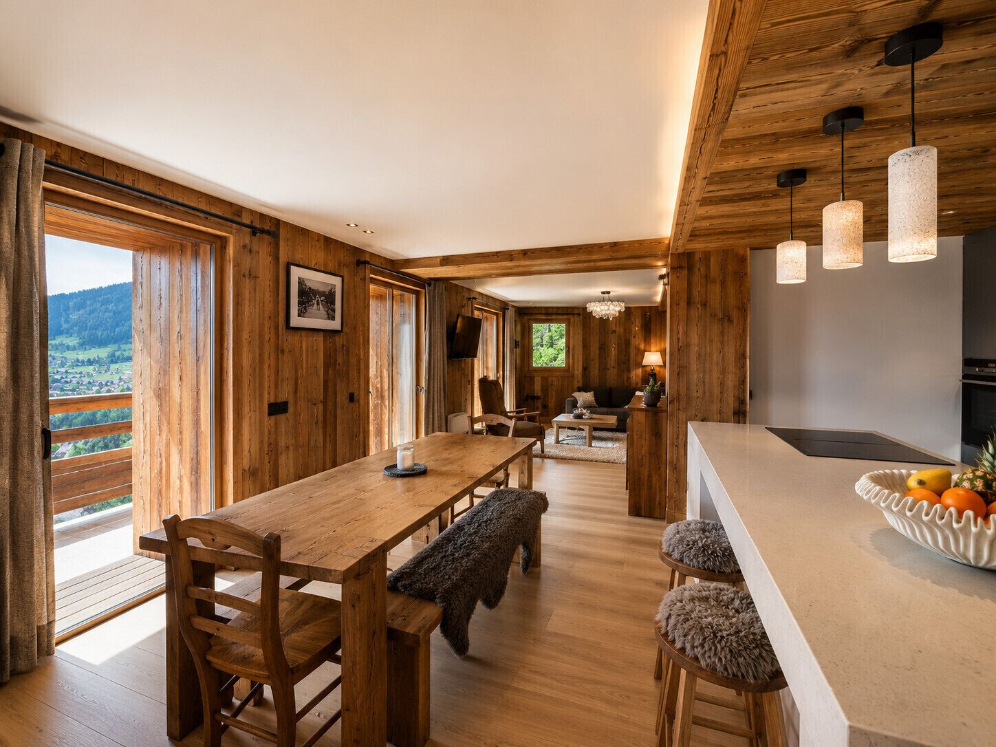 A wooden interior with a dining area, kitchen, and a view of the outdoors.