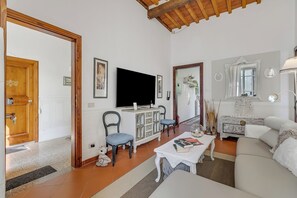 A living room with a TV, sofa, and a coffee table. - Villa Mon Paradis (Lucca)