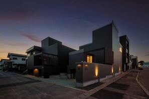 A modern hotel with a flat roof, a prominent entrance, and a well-lit facade. - THE DWBL HOTEL W (Otarushi)