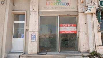 A building with a sign for 'The Lightbox - The LED Lighting Specialists' and a 'For Sale' sign.