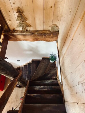 A wooden staircase with a handrail, a potted plant, and a wooden ceiling. - Maison Terese - A cozy retreat surrounded by nature and tranquility (Gressan)