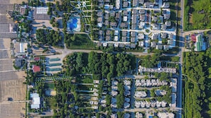 Vista aérea de una zona residencial con viviendas ordenadas, espacios verdes y un campo deportivo.