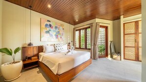 A spacious bedroom with a large bed, wooden ceiling, and a view of greenery outside. - Nala Villa Bali (Badung)