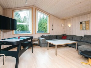 A cozy living room with a pool table, a sofa, and a TV. - 6 Person Holiday Home in Herning (Herning)